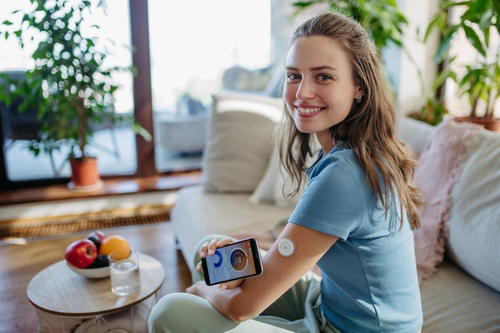 Woman with CGM device on her upper arm.jpg